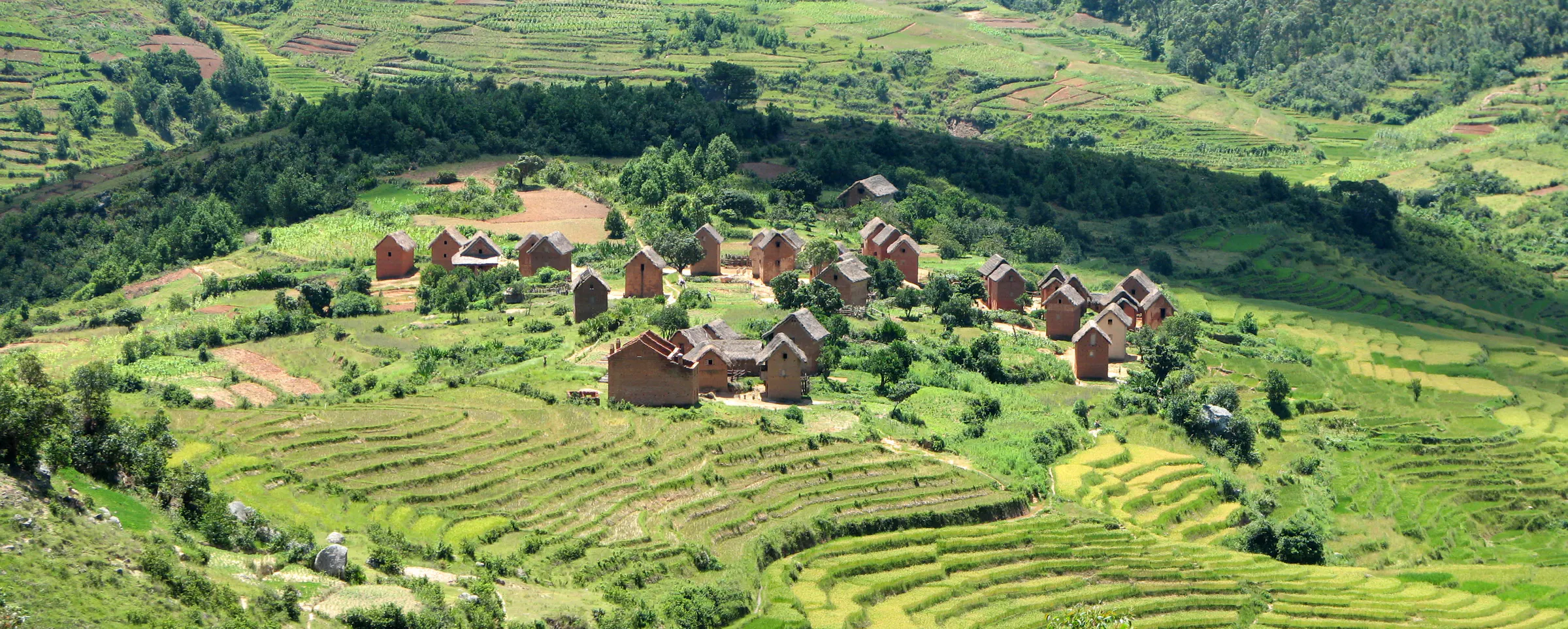 Panorama of a brick village surrounded by terraced rice paddies in the highlands