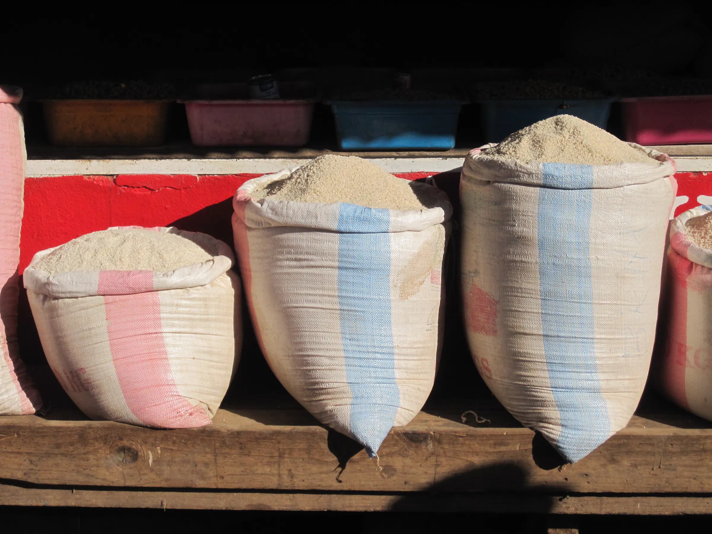 Full sacks of rice on a market stall in Ambositra